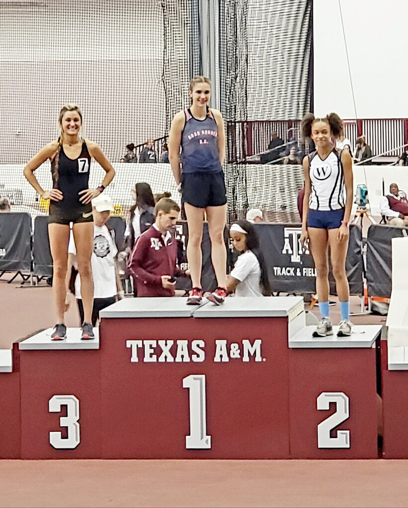 Marble Falls High School sophomore runner Bailey Goggans stands on top of the podium after her win in the 1,600 meters at the Texas A&M High School Classic over the weekend. She finished in 5 minutes 4.02 seconds. Courtesy photo