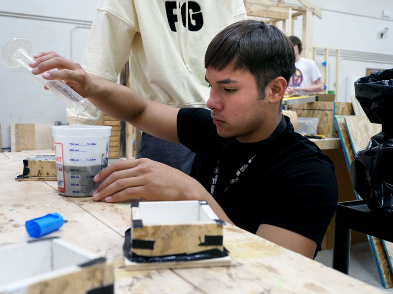 Marble Falls High School engineering students building concrete canoes