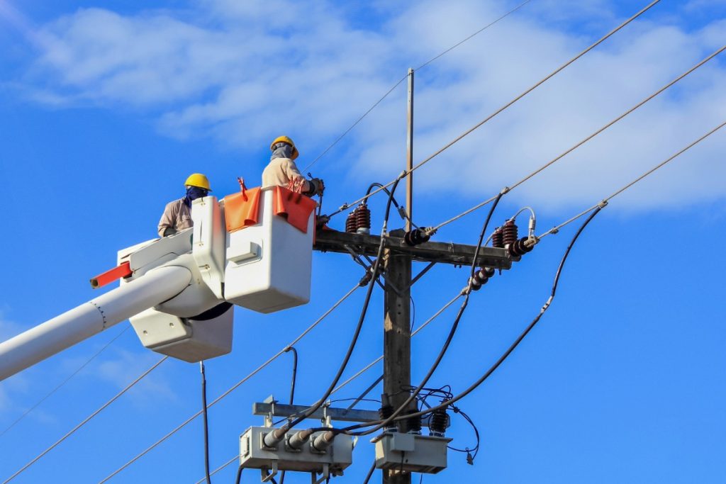 Line workers working on electric line