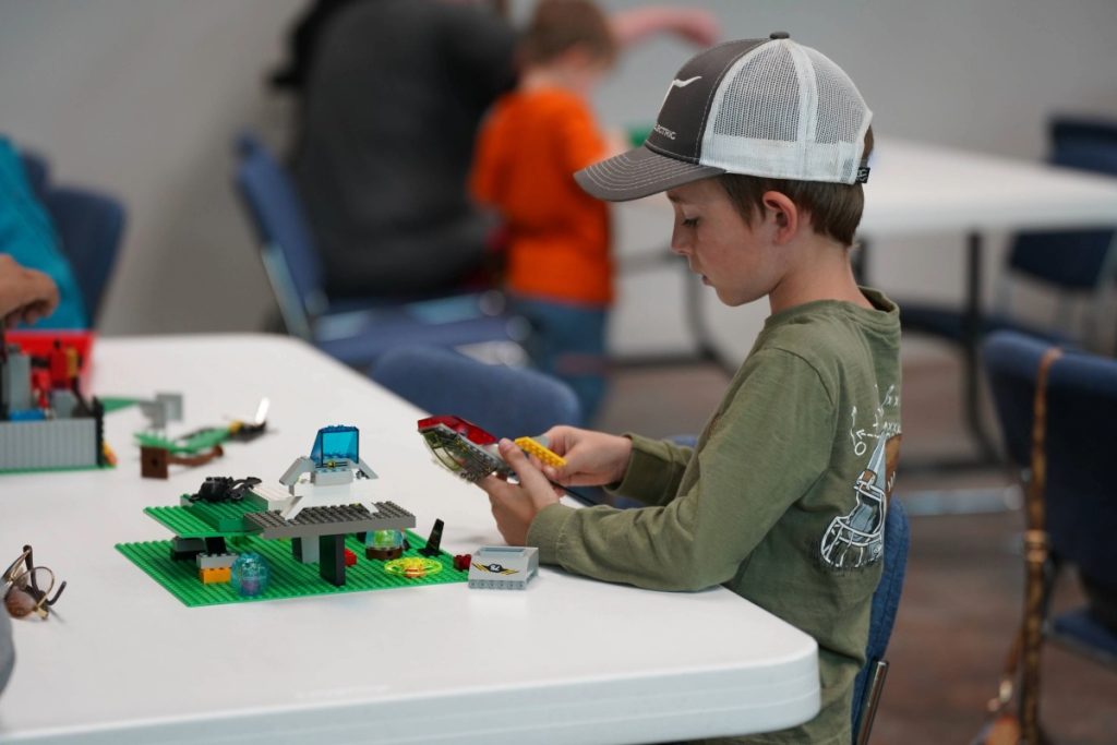 child building with Legos