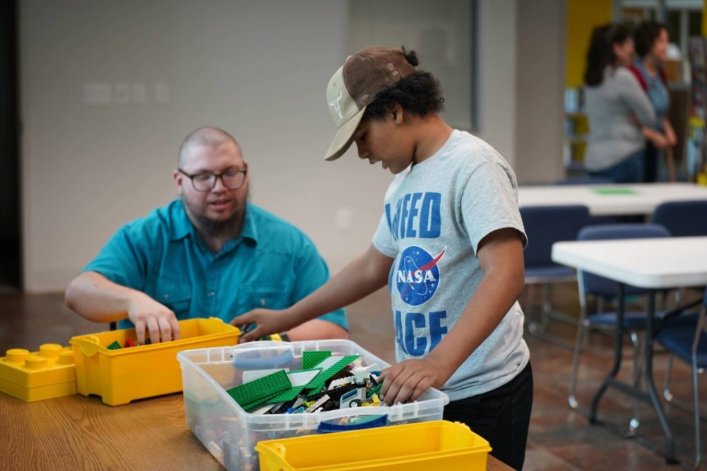 child and dad with Legos