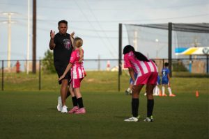 Coach James Turner high-fives Millie Rust