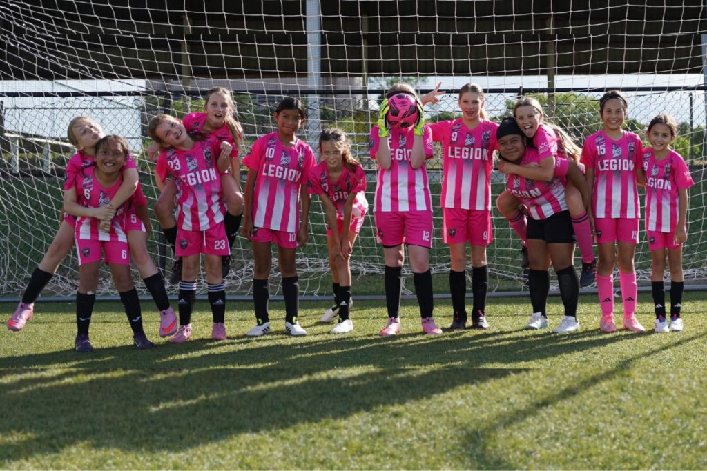 The Hill Country FC girls let loose for a silly team photo before a hard day of defensive practice.