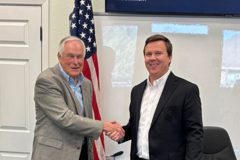 Former Meadowlakes Mayor Mark Bentley (left) shakes hands with new Mayor Garrett Wood. In a power switch, Wood ran for mayor, vacating his Place 5 council seat, and then Bentley was appointed by the City Council to take Wood’s place. Photo courtesy of Meadowlakes