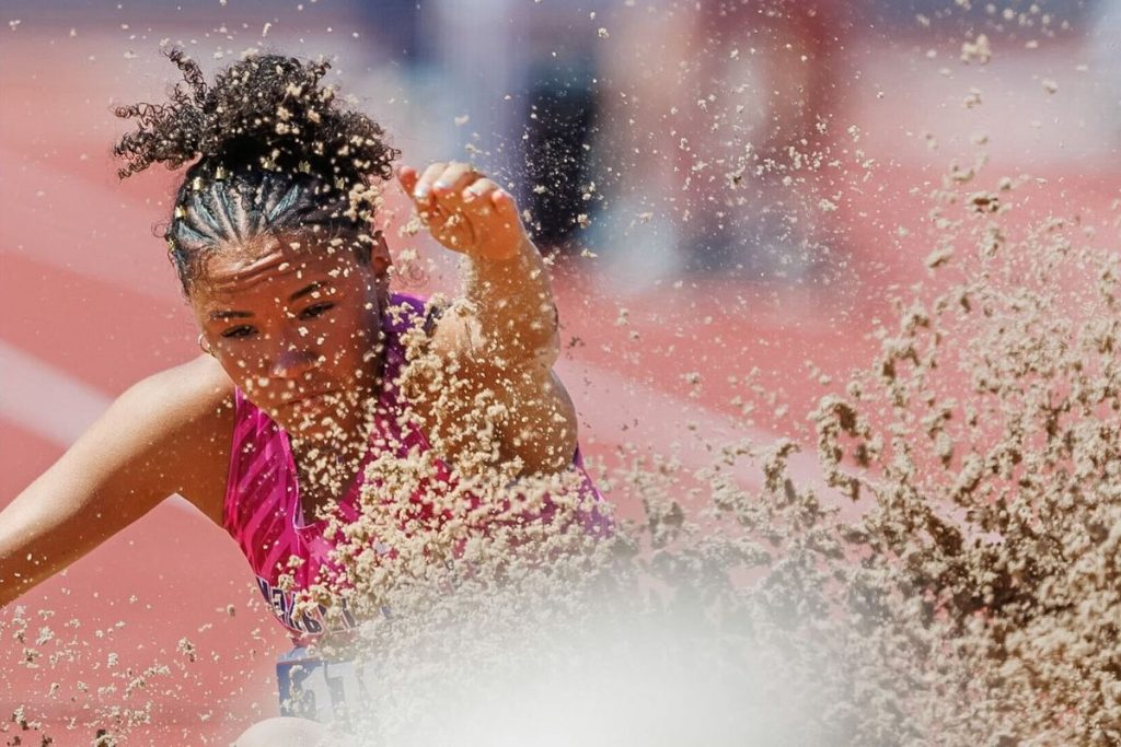 Marble Falls High School junior Madison Cuplin sends up sand at the state track and field meet on Thursday, May 14. Photo by Amir Torns