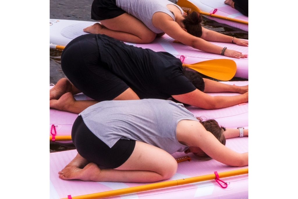 paddleboard yoga students